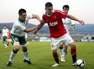 Manchester United's Robert Brady holds off the challenge of Shamrock Rovers' Darren Murray last summer.