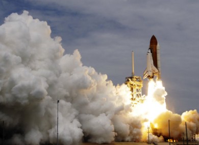 Space shuttle Atlantis lifting off from the Kennedy Space Centre