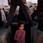 A Palestinian child waits for her mother to cross the Qalandia checkpoint on their way to pray at the Al Aqsa Mosque on the third Friday of the Muslim holy month of Ramadan, Friday, Aug. 19, 2011. 


(AP Photo/Bernat Armangue)