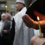 A Russian Orthodox priest prays as Moscovites light candles at a memorial to three men killed in the August 1991 hard line Communist coup attempt during a ceremony marking the 20th anniversary of the failure of the coup in downtown Moscow, Saturday, Aug. 20, 2011. 



(AP Photo/Ivan Sekretarev)