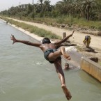 Children swim in a canal near the northern gate of Baghdad, Iraq, Tuesday, Aug. 23, 2011. 


(AP Photo / Karim Kadim)