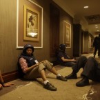 Journalists sit it out in a hallway as gun-battles continue around the Rixos hotel in Tripoli, Libya, Tuesday, Aug. 23, 2011. Dozens of journalists were trapped inside the hotel as forces loyal to Muammar Gaddafi prevented them from leaving and gun battles with rebel forces raged around the building. 


(AP Photo/Dario Lopez-Mills)