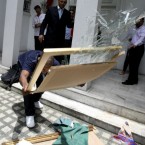 A Libyan expatriate smashes a portrait of embattled Libyan leader Col. Muammar Gaddafi after raising the Libyan rebel flag at the Libyan Embassy at suburban Makati city east of Manila, Philippines. 


(AP Photo/Bullit Marquez)