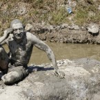 A man covered in mud sunbathes next to a small mineral spring pool in Ovca, a rural suburb of Belgrade, Serbia, Wednesday, Aug. 24, 2011. 



 (AP Photo/Darko Vojinovic)
