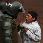 A police officer confronts a youth during clashes after the start of a national strike in Santiago, Chile, Wednesday, Aug. 24, 2011. 


Chilean students, opposition politicians and union workers are leading a two-day nationwide strike to fight for fundamental changes in government. 


(AP Photo/Roberto Candia)