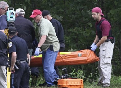 Investigators carry the body of Leonard John Egland from a wooded area in Warwick Township Pa., on Sunday Aug. 28, 2011