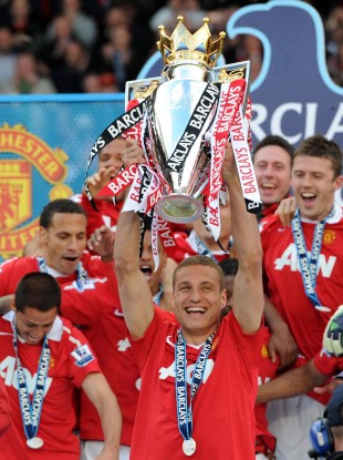 Manchester United's Nemanja Vidic lifts the Barclays Premier League trophy