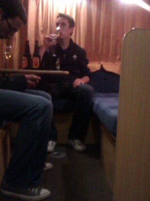 The boys enjoy a night cap before transforming the table into a bed.