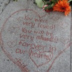 A message is displayed in front of Steve Jobs' home in Palo Alto, California. (AP Photo/Paul Sakuma)