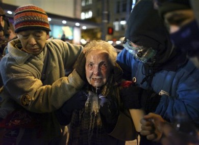 Dorli Rainey, centre, is assisted after being pepper-sprayed at the Occupy Seattle protest.