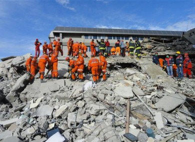 Turkish rescue workers search for survivors in the rubble of a collapsed hotel in Van, Turkey, Thursday, Nov. 10, 2011.