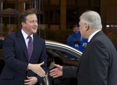 David Cameron shakes hands with Polish premier Donald Tusk arriving in Brussels last night. Talks broke up in the early hours without unanimous agreement.