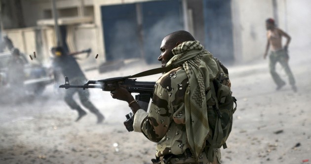 A Liben rebel fighter fires towards Gaddafi loyalists in Sirte, Libya on 19 October.