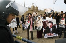 Supporters of former Egyptian leader Hosni Mubarak hold a rally outside a Cairo courthouse where Mubarak's trial resumed today. 