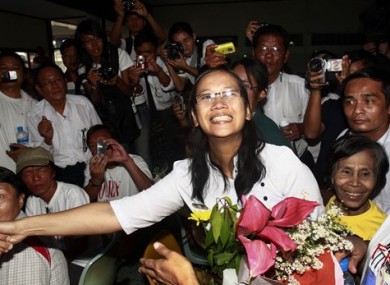 Nilar Thein, center, an activist of the 88 Generation Students Group, shakes hands with one of her colleagues as she arrives at Rangoon airport after released from Theyet prison