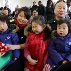 New Irish citizen He Huang from China with her partner Jun Yi Tao, her three-year-old twins Ashling Tao (left) and Alison Tao and seven-year-old Angie Tao. 

Photo: Mark Stedman /Photocall Ireland