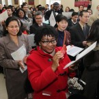 Adeola Olofa from Nigeria (front) taking her oath at the Citizenship Ceremony.
