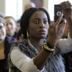 Clarible Chinedu Joku-John from Nigeria takes photos before taking her oath.