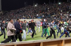 Egyptian fans rush into the field following Al-Ahly club soccer match against Al-Masry club at the soccer stadium in Port Said