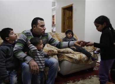 Palestinian Hussein al-Ustaz sits with his children in his house in the West Bank village of Bir Naballah on 4 February 2012.