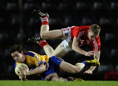 Cork's Ruairi Deane and Stephen Collins of Clare at Pairc Ui Rinn.