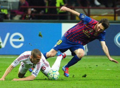 Messi under pressure at the San Siro last night.