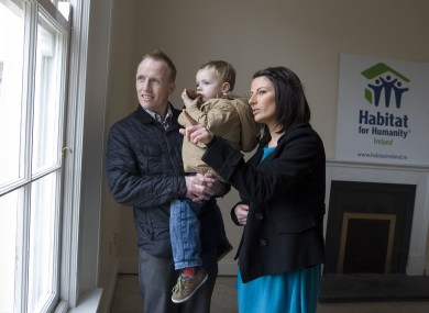 Parents Keith Greene and Jennifer Clail with their son Nathan aged 3yrs from the window of their new home in Inchicore, Dublin, which has been renovated by Habitat for Humanity Ireland in partnership with Dublin City Council.