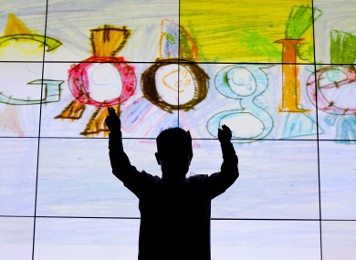 Darragh Brady from Edmondstown National School in Dublin in front of his doodle on stage at Google offices in Dublin after he won the Junior category in the 'Doodle for Google' competition in March