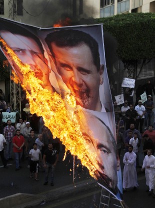 Protesters chant slogans against the Syrian regime and Russia's support of President Bashar Assad in Lebanon, Sunday, June 17, 2012