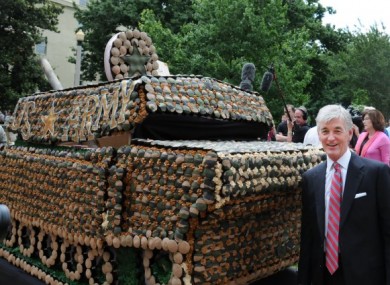Secretary of the US Army John McHugh poses with the cupcake tank.