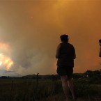 Donna Dundon, left, and Arianna Roupinian, of Fort Collins, Colorado, watch a fire burning near Fort Collins yesterday. (AP Photo/The Denver Post, Helen H Richardson)