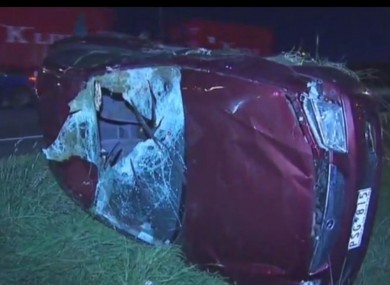 The damage to one car after sheep falling from a truck struck motorists below a bridge