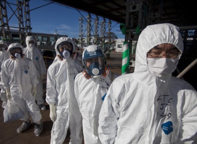 File photo (2011) shows workers in protective suits and masks wait to enter the emergency operation center at the crippled Fukushima Dai-ichi plant
