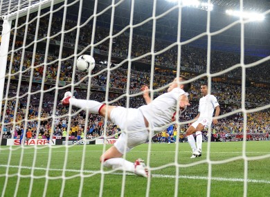 England's John Terry attempts to clear the ball off the line. No goal is awarded.