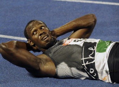 World-record holder Usain Bolt looks at the crowd while getting his right hamstring stretched out after losing to fellow country man Yohan Blake recently.