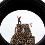 A man stands on top of the New Mossley bonfire (Paul Faith/PA Wire)
