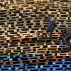 Children climb the Shankill bonfire (AP Photo/Peter Morrison)