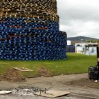 A child plays beside a massive bonfire in the Shankill Estate in West Belfast (AP Photo/Peter Morrison)
