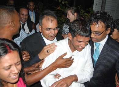 Avinash Treebhoowoon (white shirt) outside the Supreme Court in Port Louis, Mauritius, after he was acquitted of murdering honeymooner Michaela McAreavey.
