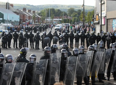 Police line up against protesters in Ardoyne