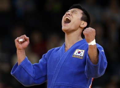 Jun-Ho Cho of South Korea celebrates but the winning decision would be reversed.