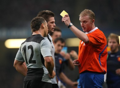 Referee Wayne Barnes gives Luke McAlister a yellow card in 2007.