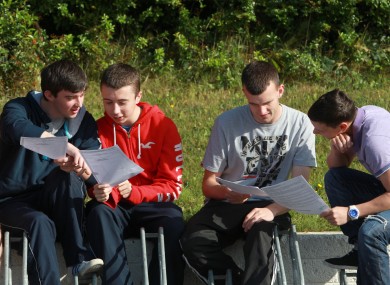 Students at St Kevin's College in Glasnevin examine their results last year. 55,815 students will receive their Leaving Cert results today.