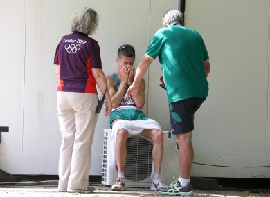 Rob Heffernan is consoled by an Olympic volunteer and Irish athletic team manager Patsy McGonagle after finishing 4th.