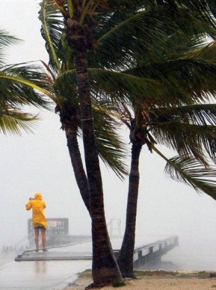A person braves the rain at Clarence Higgs Beach in Key West, Florida.