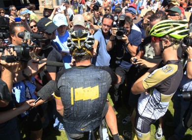 Lance Armstrong, center, talks to reporters after his second-place finish in the Power of Four race in Aspen, Colorado on Saturday.