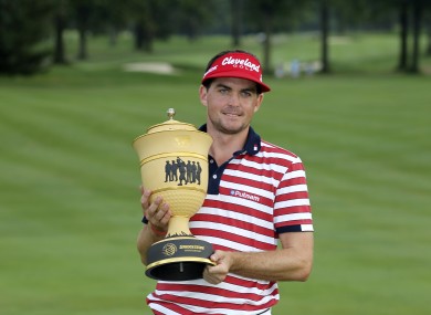 Keegan Bradley holds up the trophy after winning the Bridgestone Invitational.