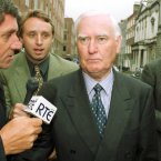 Questioning the former Chairman of Allied Irish Bank, Jim Culliton (c), as he leaves the Public Accounts Committee hearings in Kildare House in Dublin in 1998. 