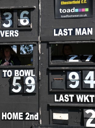 An old fashioned cricket scoreboard in operation at Queens Park, Chesterfield, England.