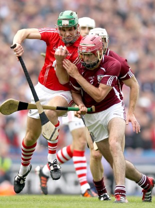 Cork's Eoin Cadogan and James Regan of Galway battle in yesterday's game.